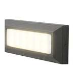 Rectangular surface-mounted step light on white, warm LEDs glowing behind a frosted lens.