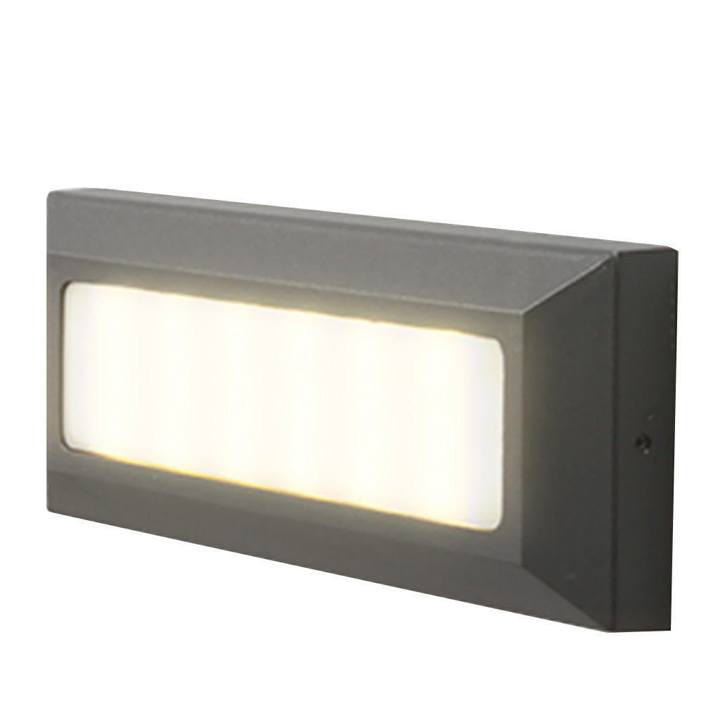 Rectangular surface-mounted step light on white, warm LEDs glowing behind a frosted lens.