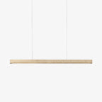 Cropped close on a plain light backdrop, this Clérachic pendant's travertine bar is shown unlit.