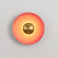 A tighter crop shows the antique copper centre of this coral-orange Clérachic wall light glowing bright.