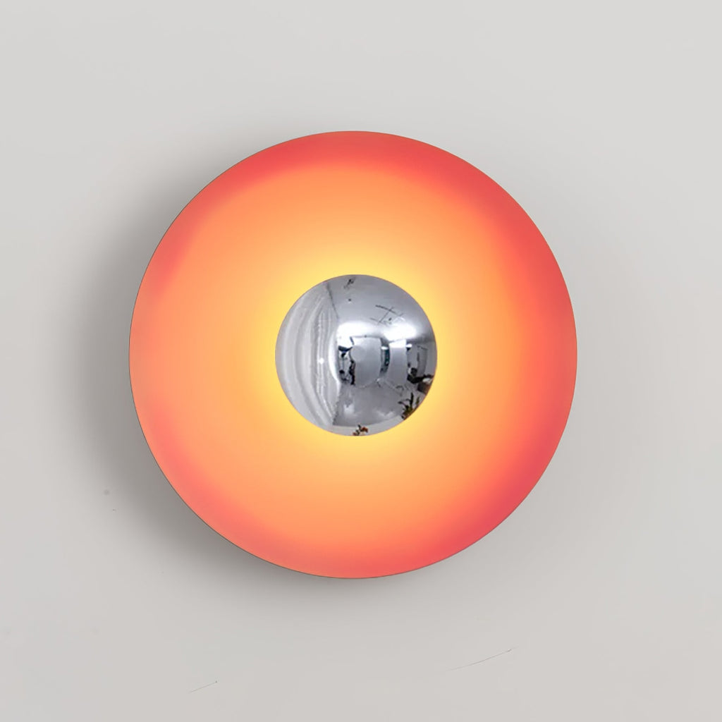 This coral-orange Clérachic wall light's chrome centre catches a warm highlight, isolated against grey.
