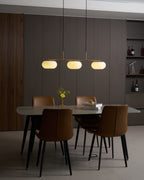 Detail of pendant light bar with three glowing glass globes