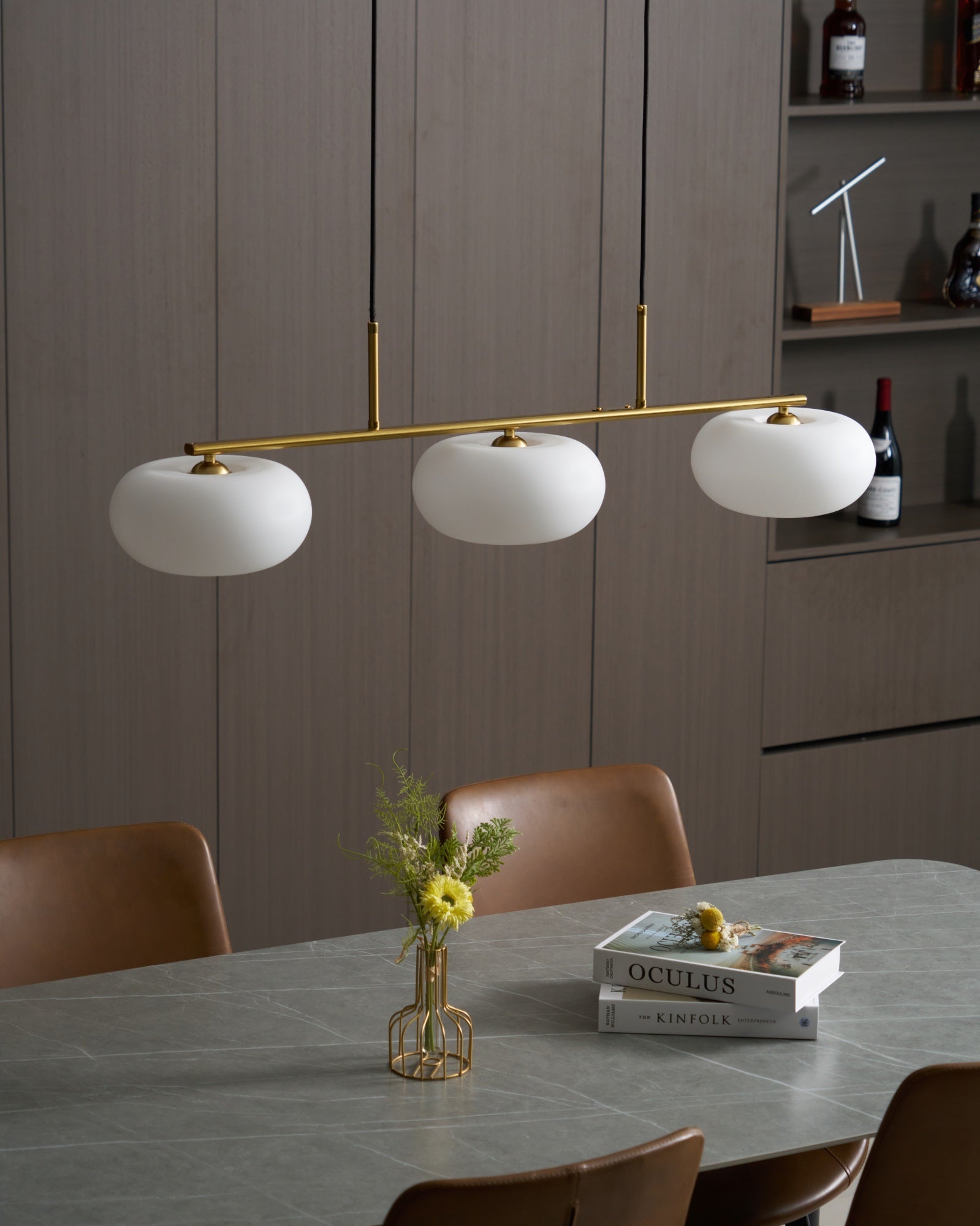 White glass globe shade and slim cable of a pendant light