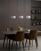 Warm glowing white glass globe on a modern pendant light