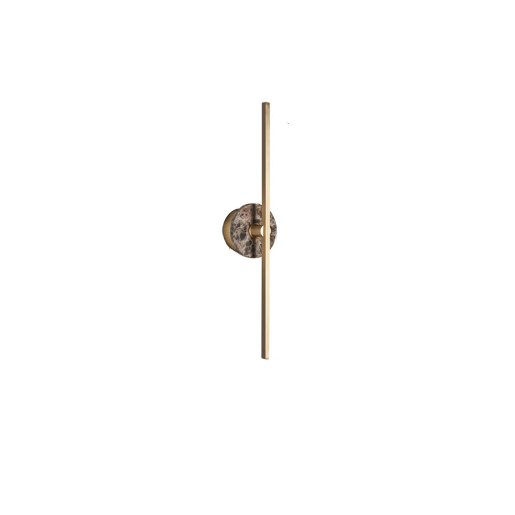 Clérachic wall light on white, a warm brown marbled disc set low on its slender brass bar.