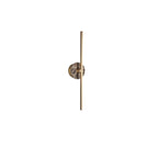 Clérachic wall light on white, a warm brown marbled disc set low on its slender brass bar.