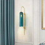 Modern glass wall sconce mounted with warm cylinder glow
