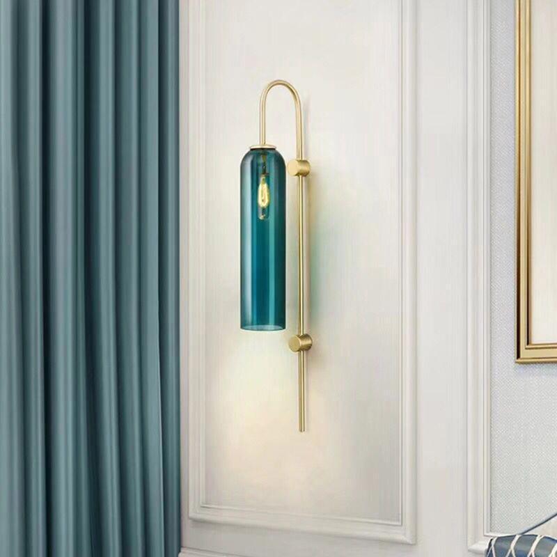 Modern glass wall sconce mounted with warm cylinder glow
