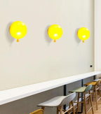Playful balloon wall sconce with rounded coloured shade