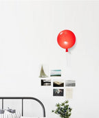 Balloon-shaped wall light mounted on a feature wall