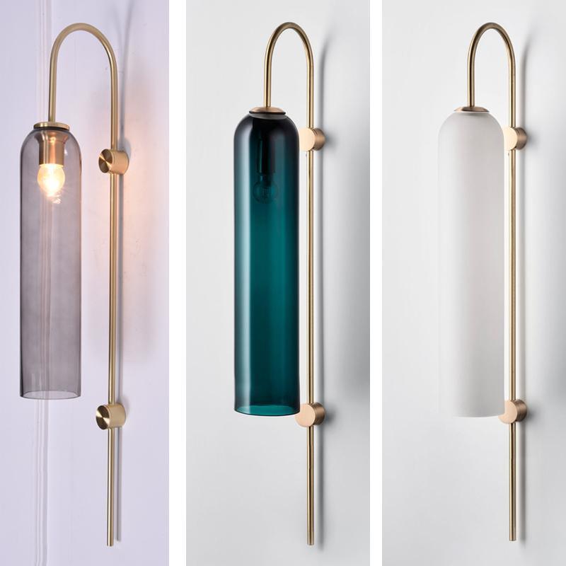 Modern glass wall sconce detail of the brass mounting discs