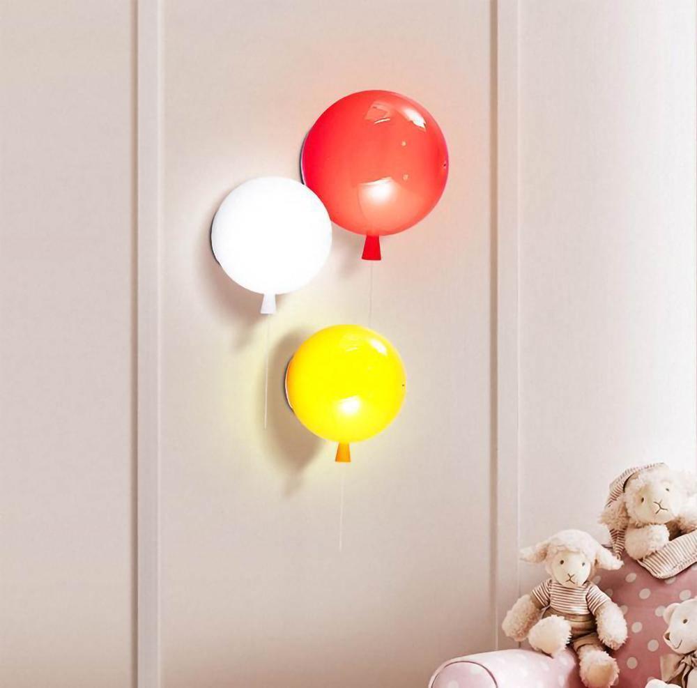 Colourful balloon wall sconce glowing against a pale wall