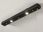 Close view of the black linear canopy plate on this Clérachic fixture, with its spotlights and cable points.