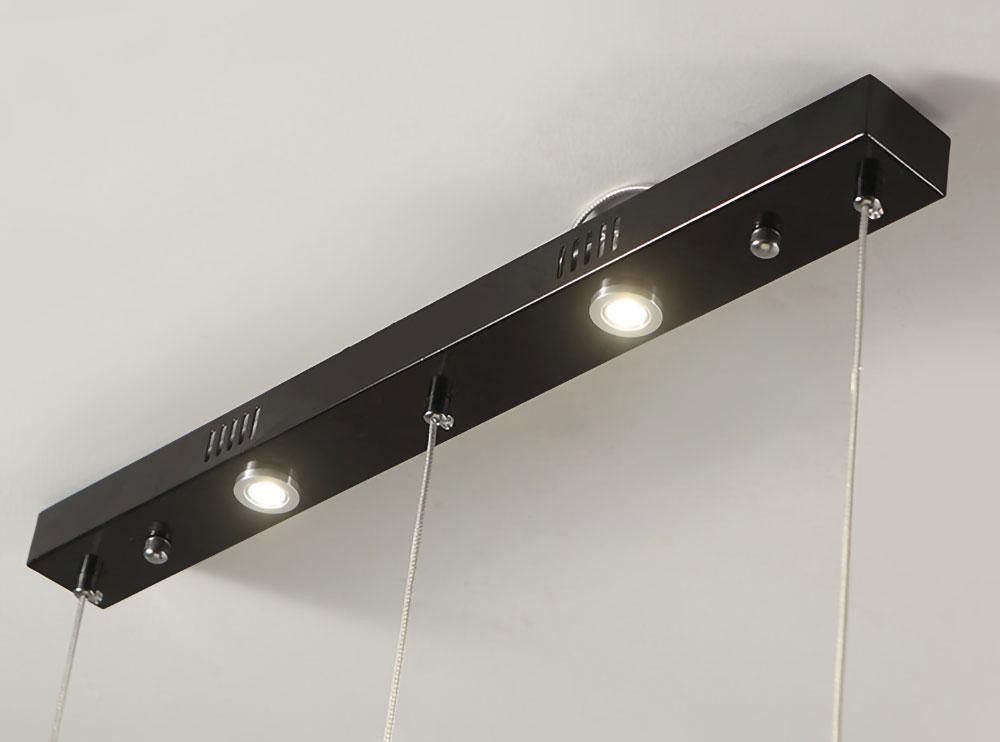 Close view of the black linear canopy plate on this Clérachic fixture, with its spotlights and cable points.