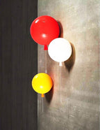 Balloon-shaped wall sconce in a bright playful room