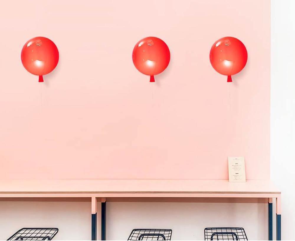 Balloon-shaped wall light lit warmly in an interior