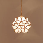 Glass petal pendant light with warm brass fitting close up