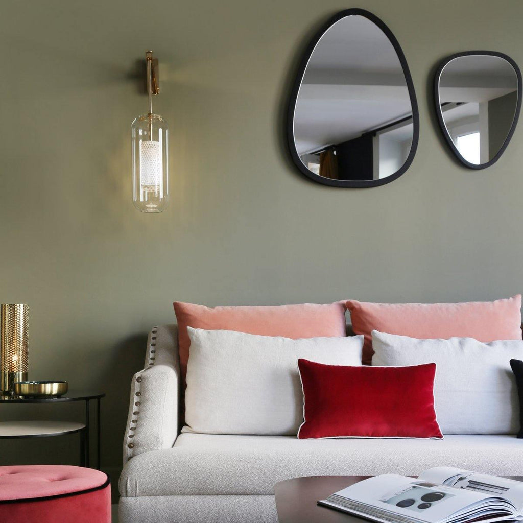 Wall lamp with glass shade mounted above a seating area