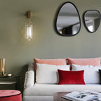 Wall lamp with glass shade mounted above a seating area