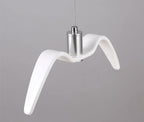 A single white bird-shaped pendant from this Clérachic light is seen in profile against a plain grey backdrop.