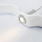 Close view of the warm LED spotlight set into the resin wing of this white Clérachic pendant.