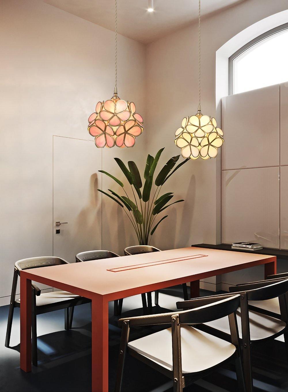Glass petal pendant lights grouped above a dining table
