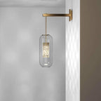 Glass wall lamp with slim arm mounted beside framed wall art