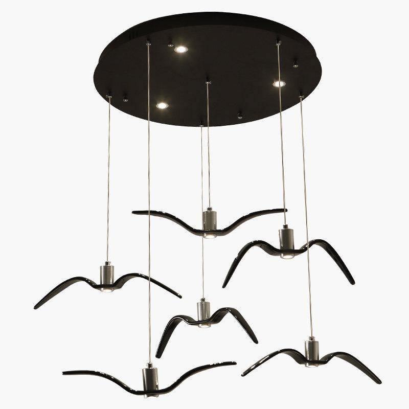 Six black bird-shaped pendants from this Clérachic fixture hang from a round black canopy, seen from above.