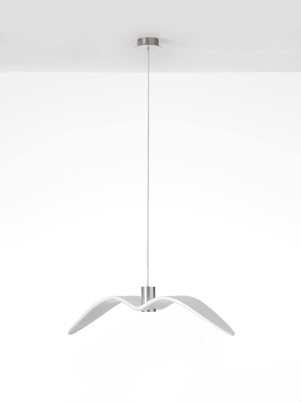 A white bird-shaped pendant from this Clérachic fixture hangs with its wings swept narrow, on a plain white backdrop.