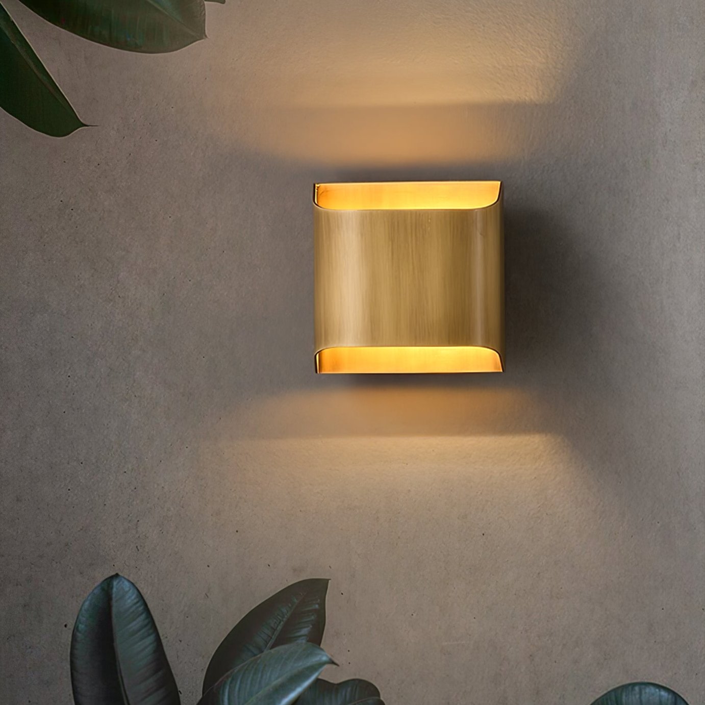 Solid brass wall sconce photographed against a dark backdrop