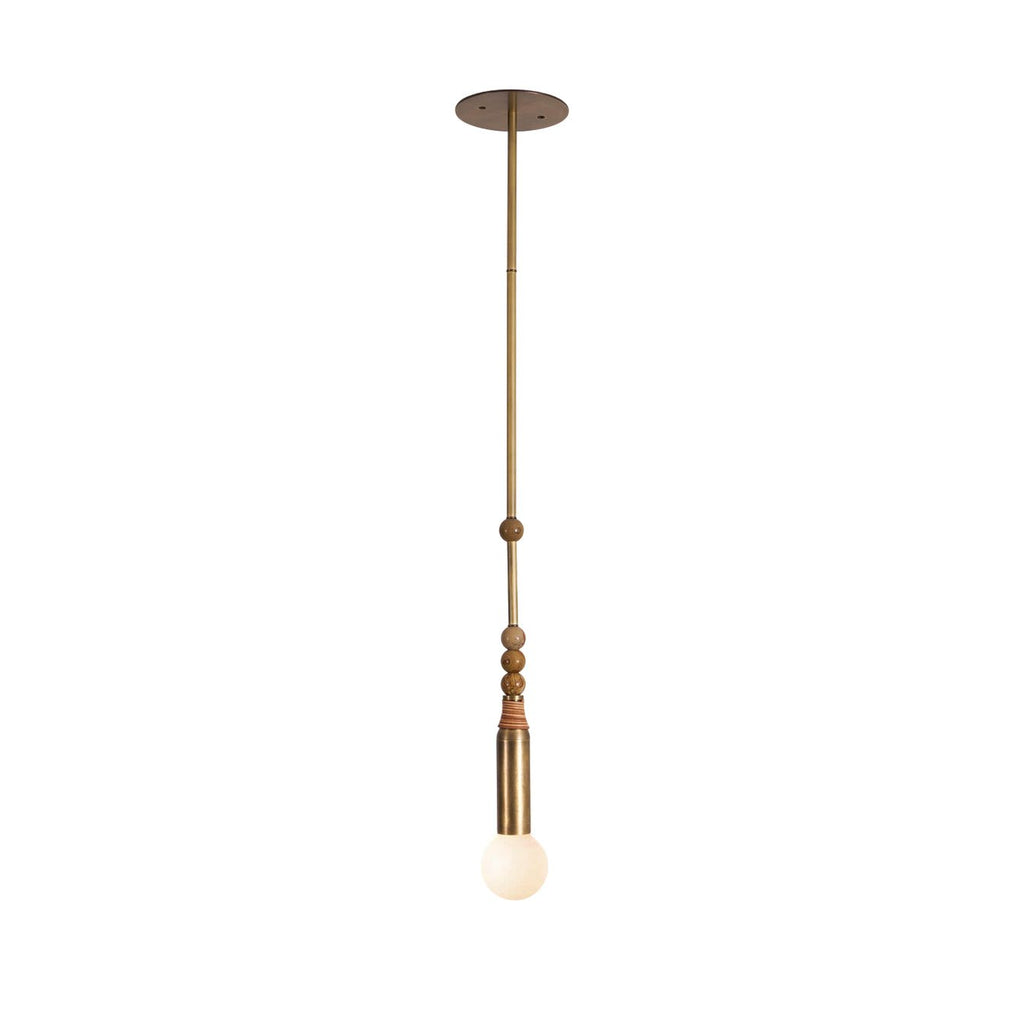 A studio view of the Clérachic pendant light's full brass rod and marble bead detail on a neutral background.