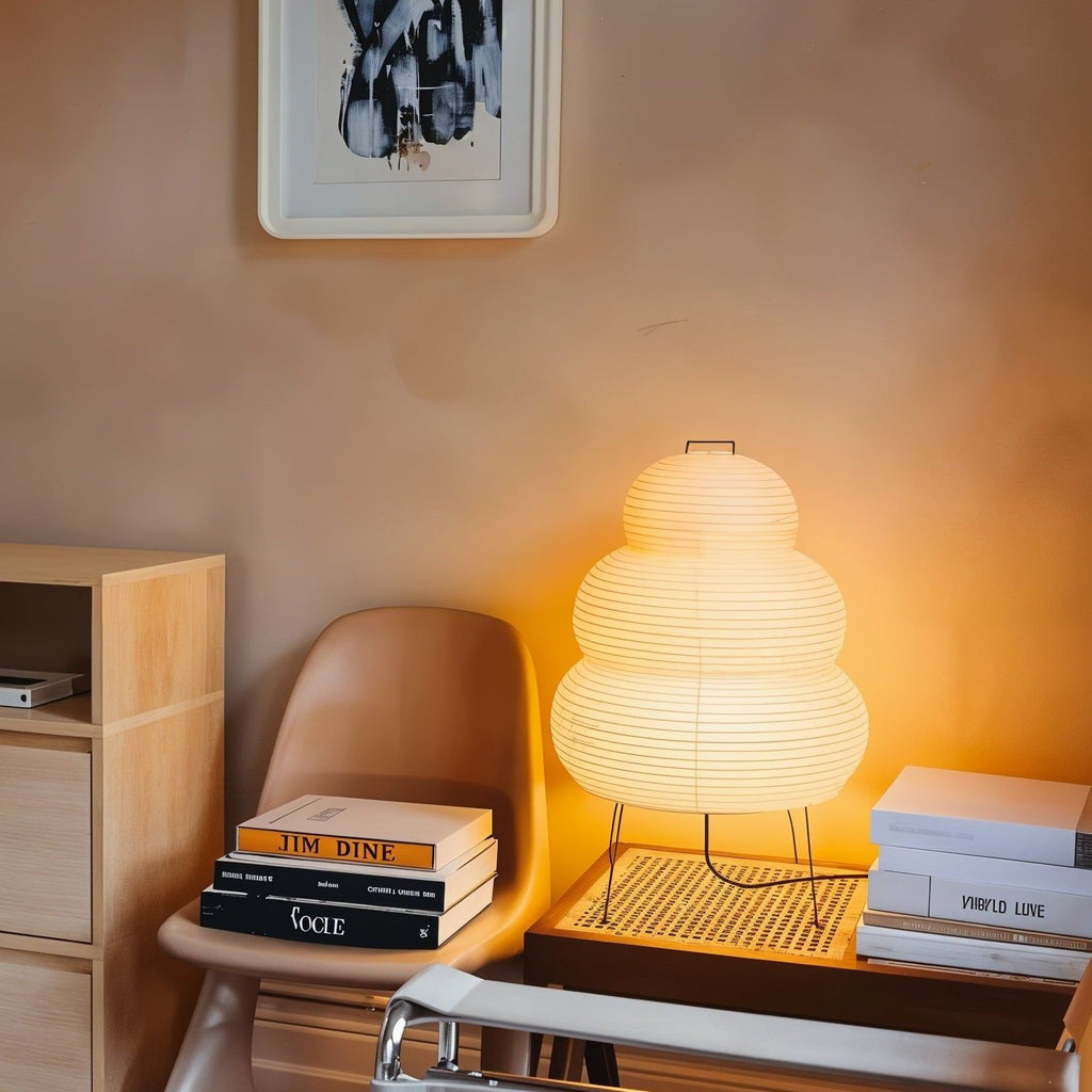 White paper lantern table lamp shown close up on a surface