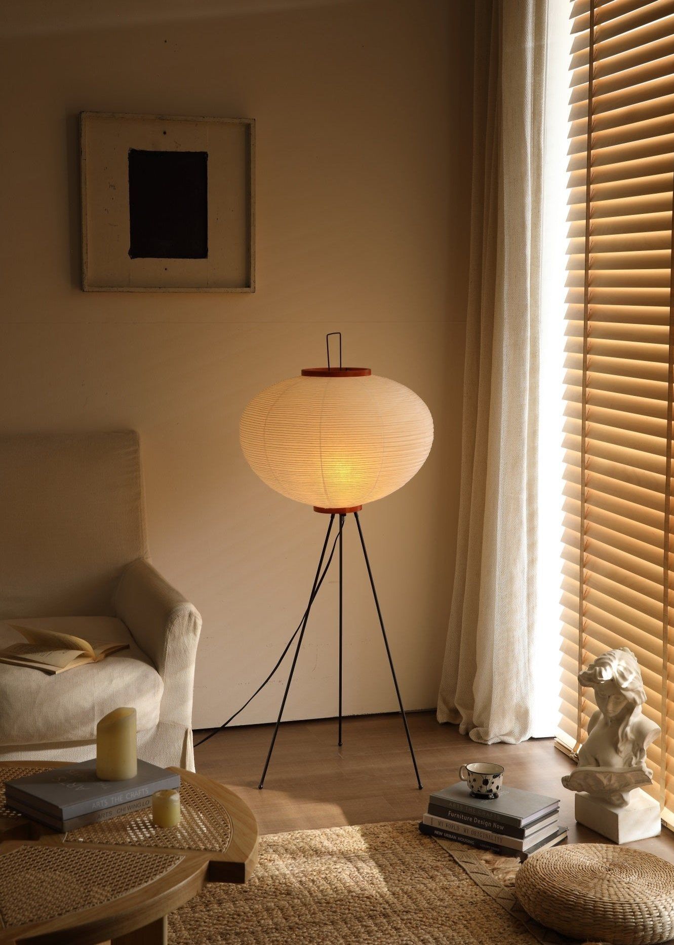 White Akari paper floor lamp glowing in a quiet corner