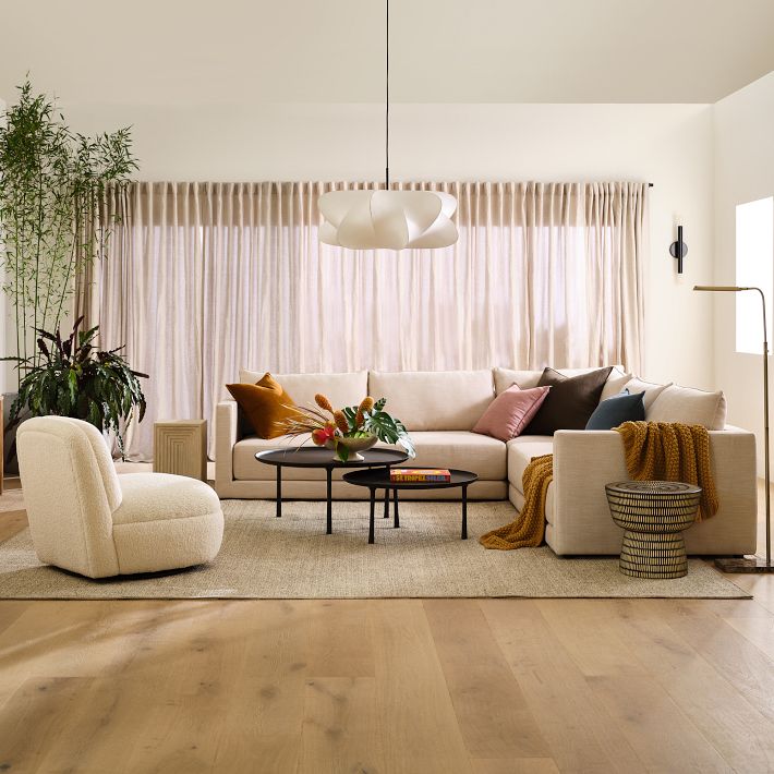 Elysia pendant light glowing above a living room seating area