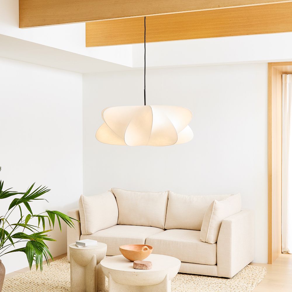 Silk cocoon pendant light hanging in a calm, modern interior