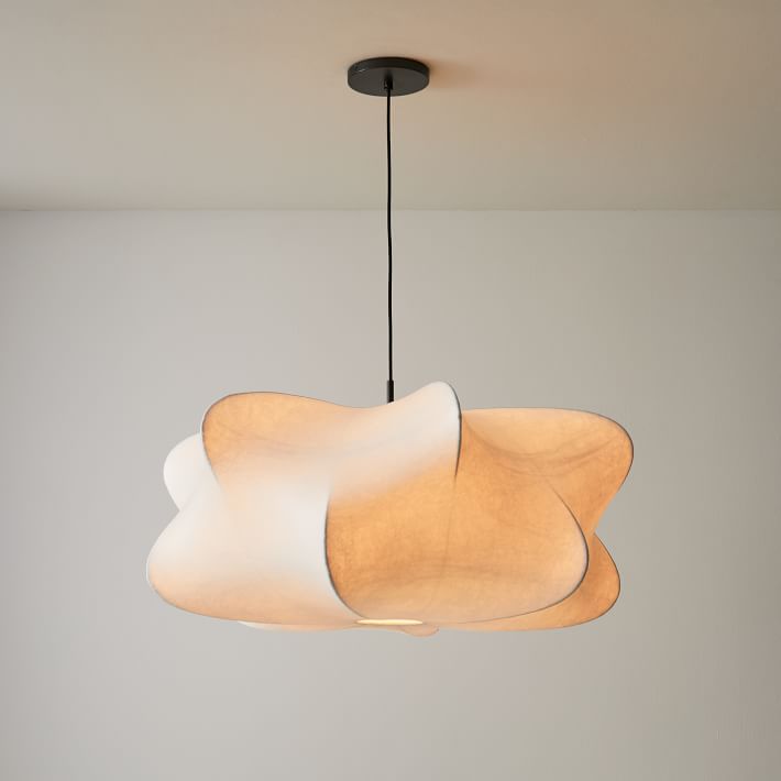 Silk cocoon pendant light hanging in a warm, modern home