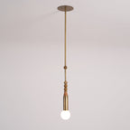 An antique brass Clérachic pendant light shown full length from its round ceiling canopy to the frosted bulb, on a plain backdrop.