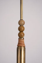Close-up of the stacked marble beads and leather-wrapped brass sleeve on this Clérachic pendant light's drop rod.