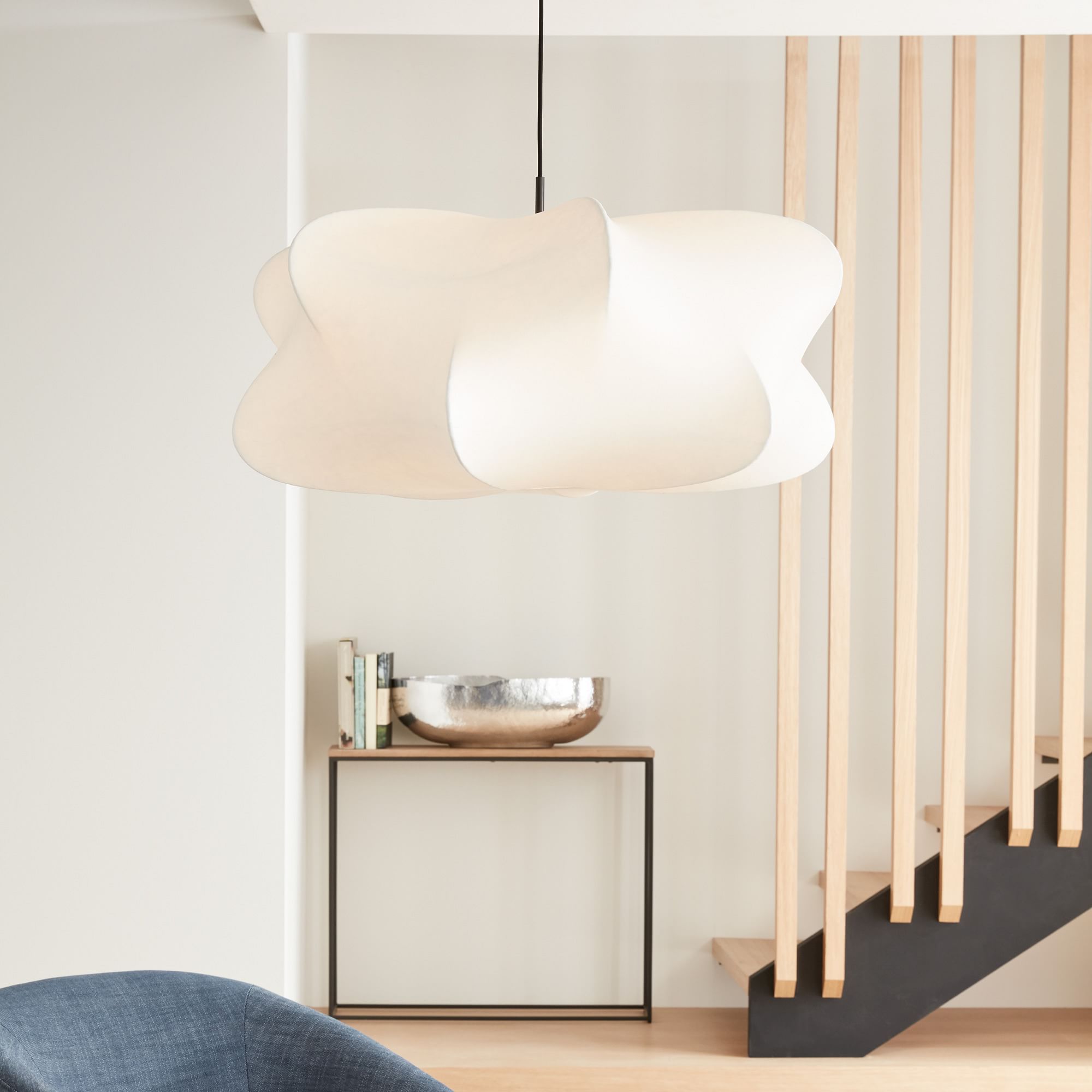 Elysia pendant light casting soft diffused light in a living room