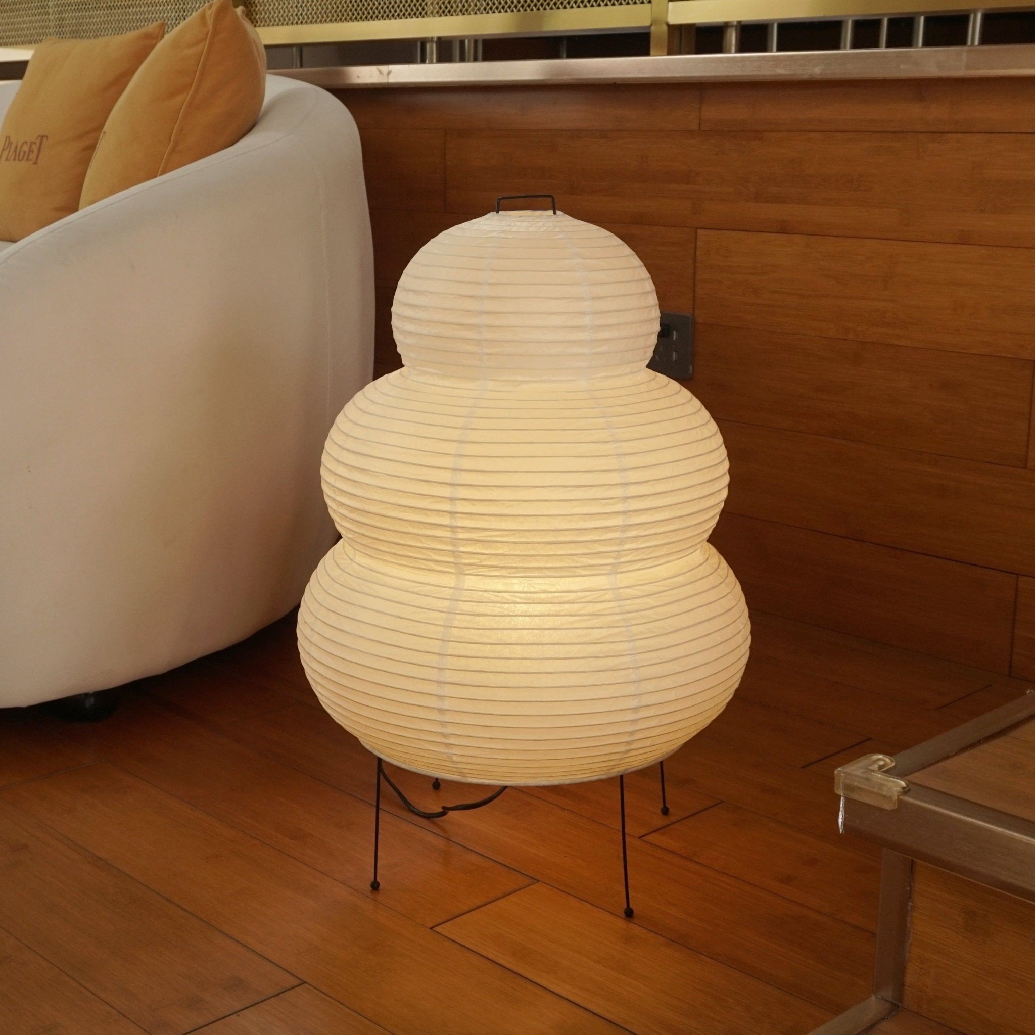 Handmade paper table lamp shown close up on a surface