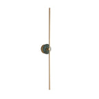 Clérachic wall sconce on a white background, a deep green stone disc crossing the middle of its slender brass bar.