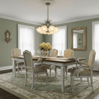 Close beneath the ceiling in a sage-green dining room, this Clérachic chandelier lights a table set for guests.