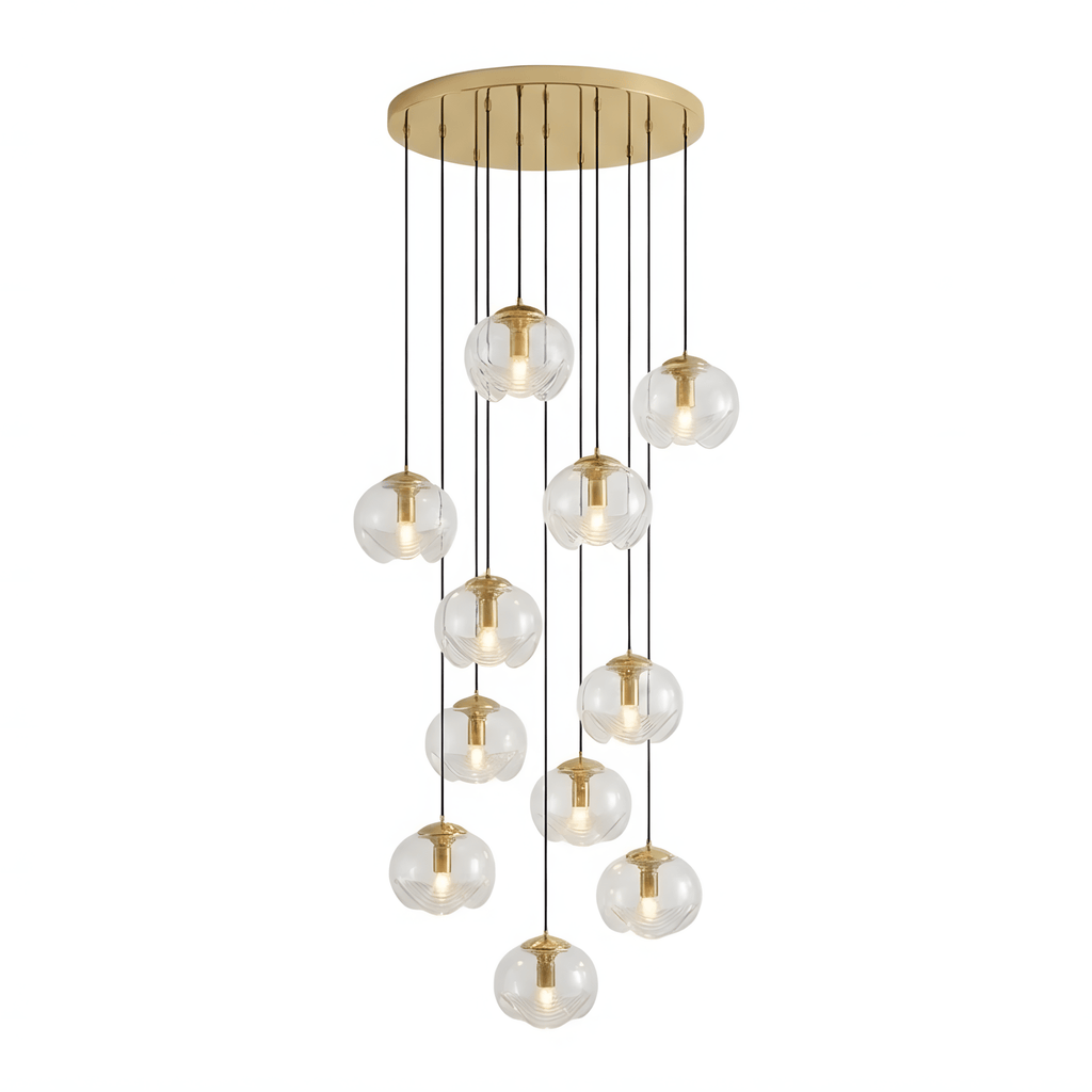 A large dense cascade of amber glass shades drops from a gold ceiling plate, this Clérachic fixture shown on a white background.