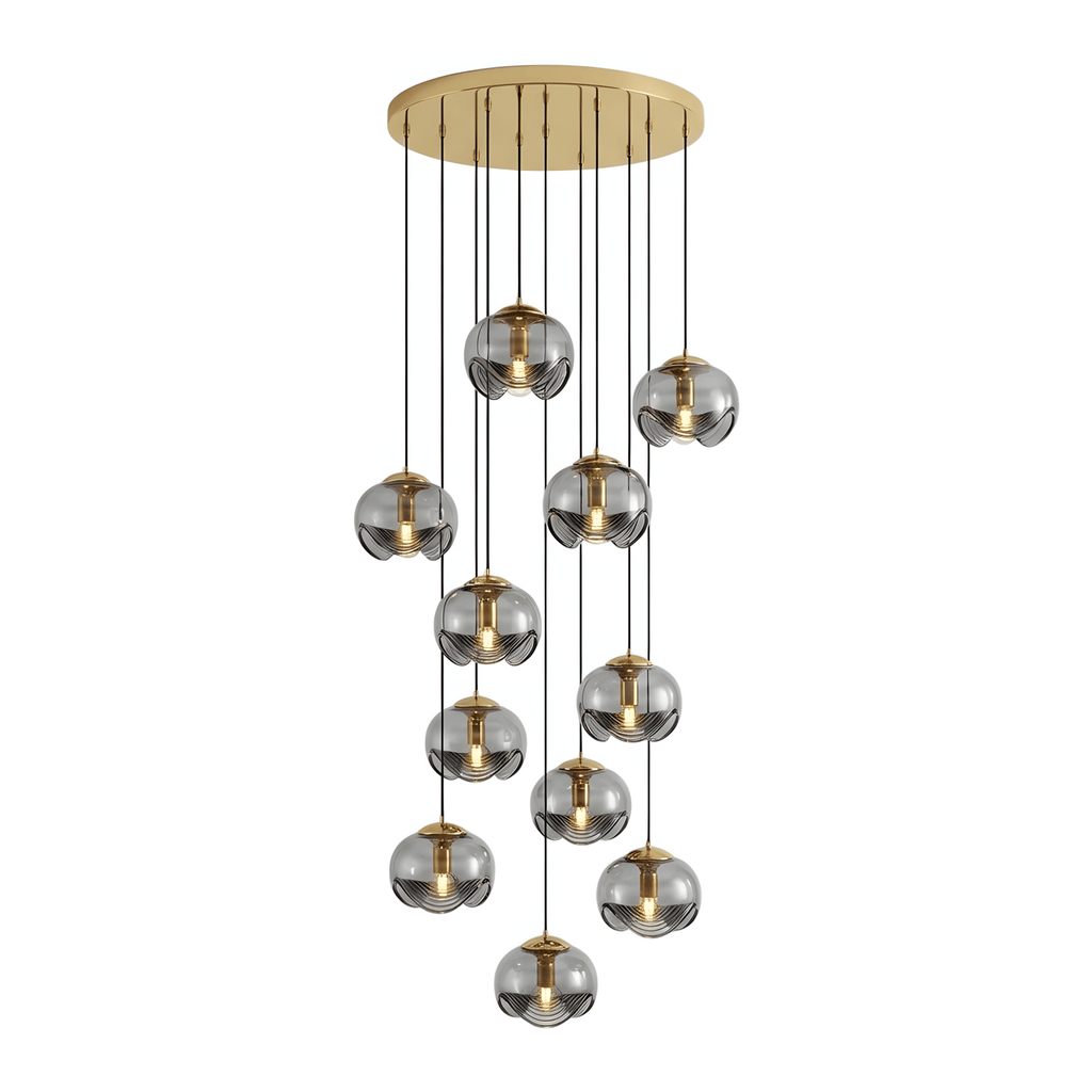 Smoky grey glass shades cascade unevenly from a gold ceiling plate, this Clérachic fixture shown in a tall cluster on white.