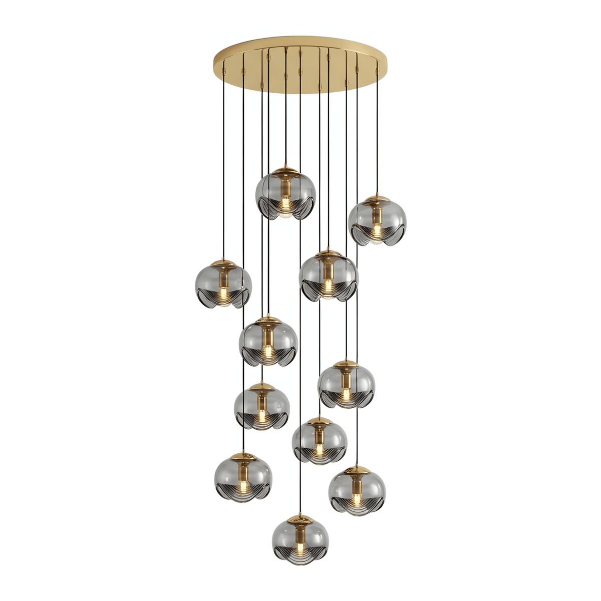 Smoky grey glass shades cascade unevenly from a gold ceiling plate, this Clérachic fixture shown in a tall cluster on white.