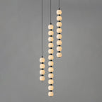 Four, twelve and eight-ball Orbique pendants lit together against a plain grey backdrop
