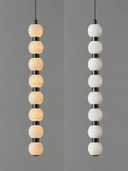 Eight-ball Orbique pendant lit on the left and unlit on the right, showing the alabaster veining
