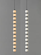 Twelve-ball Orbique pendant side by side, lit on the left and switched off on the right