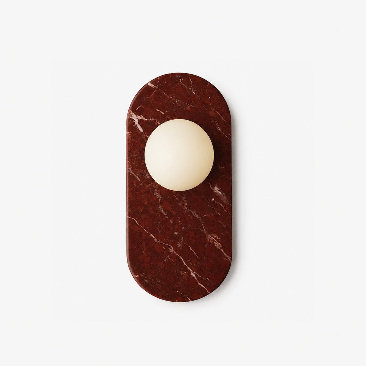 An opal glass sphere set into a deep red marble oval, the Clérachic wall sconce photographed flat against white.