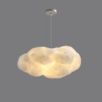 This Clérachic cloud-shaped pendant hangs lit against a plain grey backdrop, its canopy visible.